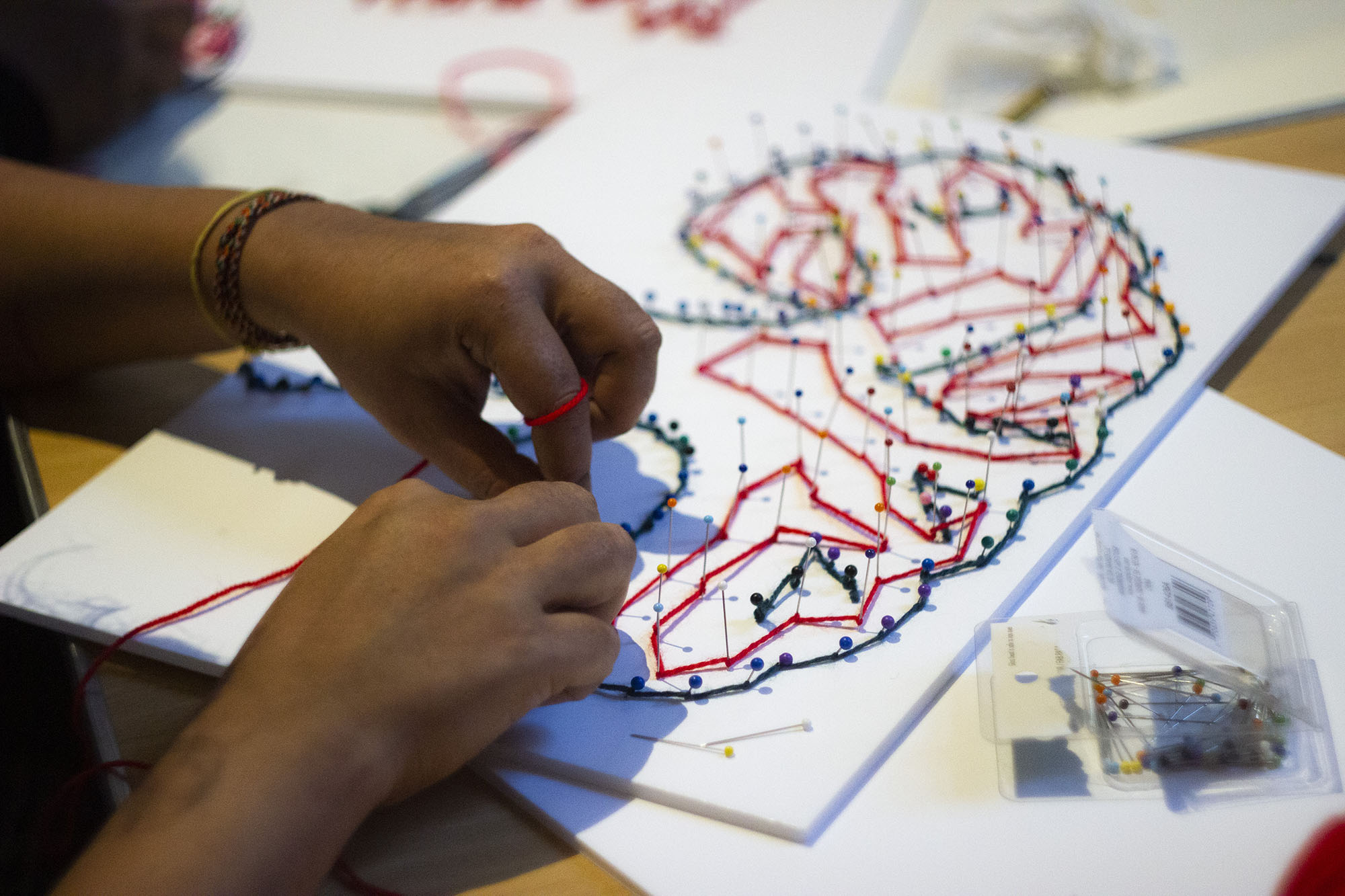 Child creating artwork of a tree.